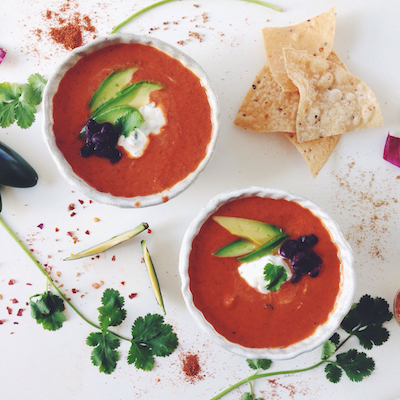 FIRE ROASTED CHIPOTLE TOMATO SOUP WITH CILANTRO LIME CREMA & BLACK BEANS.